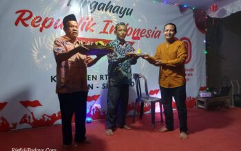 Edi Prayitno Ketua RT 22 RW 03 Kel. Kalijaten Taman menyerahkan potongan tumpeng kepada sesepuh warga dalam momen tasyakuran malam 17 Agustus